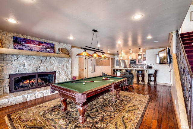 rec room with dark wood-style floors, recessed lighting, a fireplace, and pool table