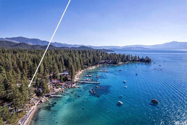 aerial view with a forest view and a water and mountain view