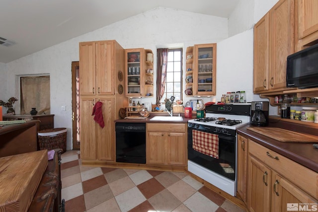 kitchen with black appliances, sink, and vaulted ceiling