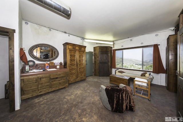 living area with unfinished concrete flooring