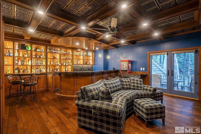 bar with french doors, dark wood-style flooring, coffered ceiling, and wet bar