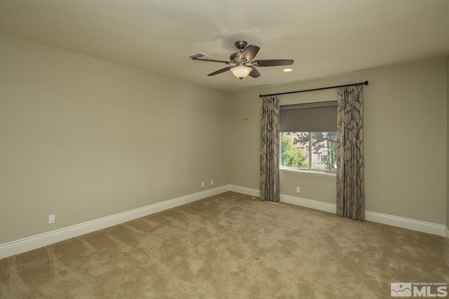 spare room with recessed lighting, carpet flooring, visible vents, a ceiling fan, and baseboards