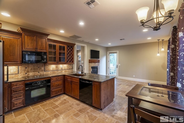 kitchen with black appliances, visible vents, and stone tile flooring