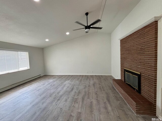 unfurnished living room with dark hardwood / wood-style flooring, a fireplace, a baseboard radiator, lofted ceiling, and ceiling fan