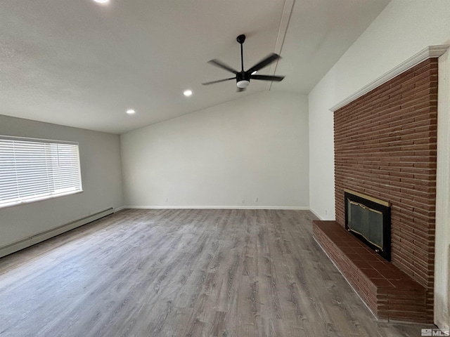 unfurnished living room with baseboards, a fireplace, wood finished floors, a ceiling fan, and a baseboard radiator
