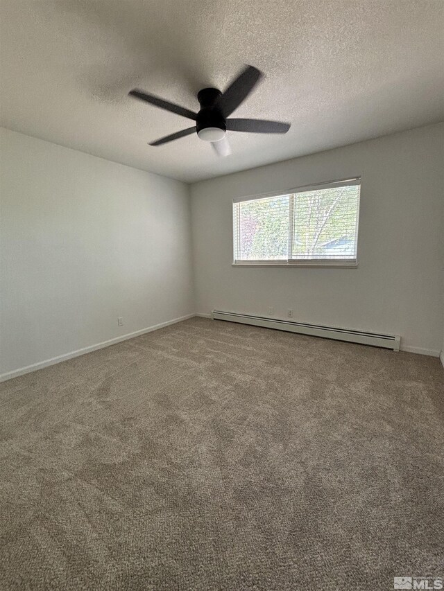 carpeted empty room featuring ceiling fan, a baseboard radiator, and a textured ceiling