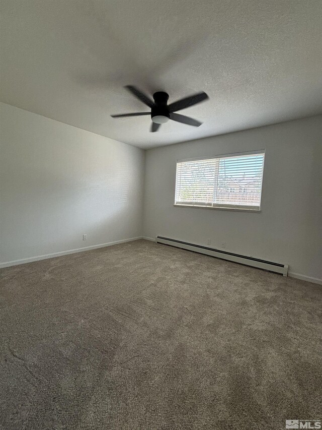 carpeted spare room with a baseboard heating unit, ceiling fan, and a textured ceiling