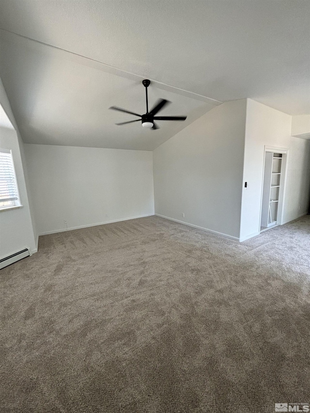 unfurnished living room featuring baseboards, a ceiling fan, lofted ceiling, and carpet
