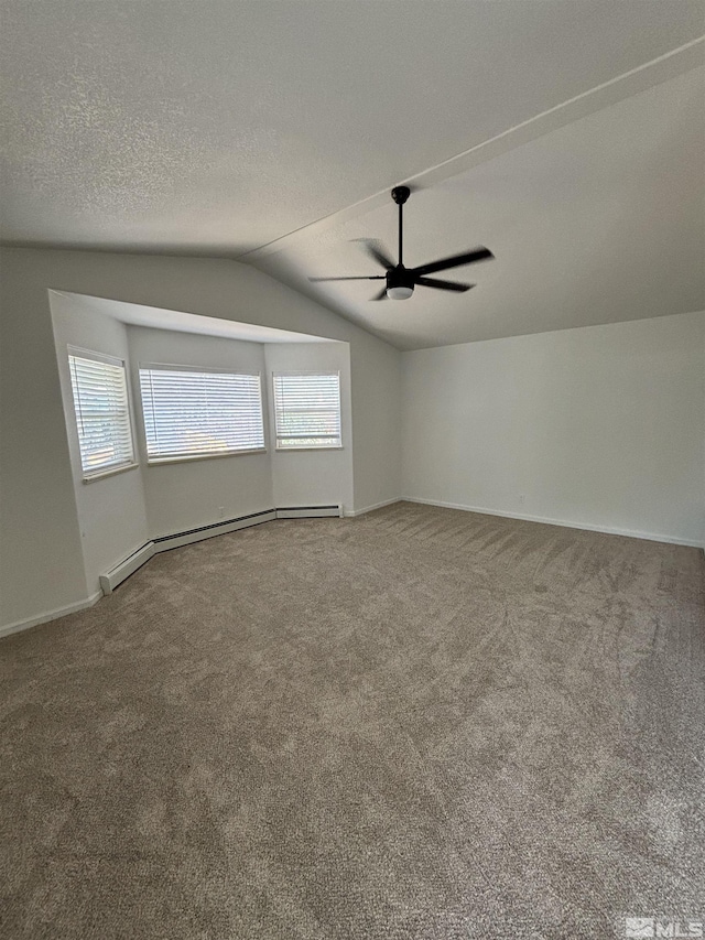 empty room featuring ceiling fan, lofted ceiling, carpet flooring, a textured ceiling, and a baseboard radiator