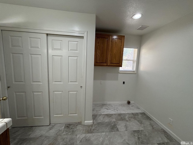laundry area featuring baseboards, visible vents, cabinet space, electric dryer hookup, and marble finish floor