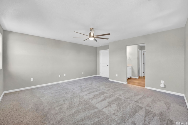 carpeted empty room featuring ceiling fan