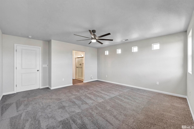 carpeted empty room featuring a textured ceiling and ceiling fan