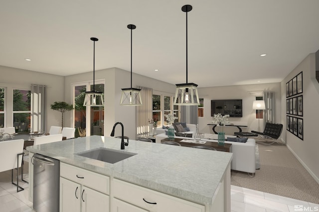 kitchen with white cabinetry, sink, pendant lighting, light colored carpet, and a kitchen island with sink