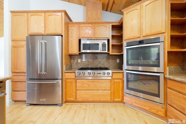 kitchen featuring tasteful backsplash, stainless steel appliances, vaulted ceiling, and light wood-type flooring