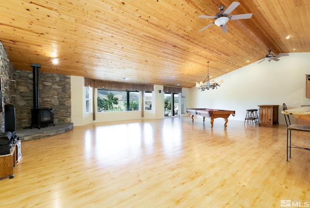 playroom featuring a wood stove, lofted ceiling with beams, wood ceiling, and light wood-type flooring