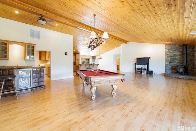 playroom with a wood stove, light hardwood / wood-style floors, and billiards