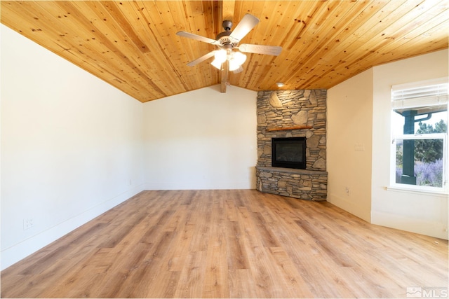 unfurnished living room featuring vaulted ceiling, ceiling fan, light hardwood / wood-style flooring, wooden ceiling, and a stone fireplace