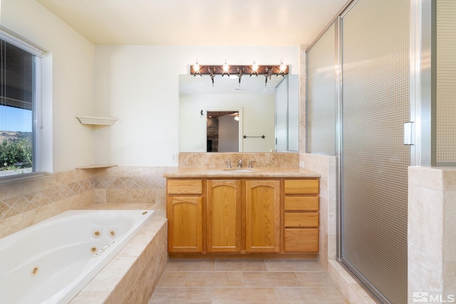 bathroom with tile patterned floors, vanity, and shower with separate bathtub