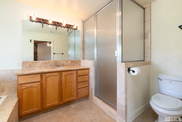 full bathroom with vanity, separate shower and tub, ceiling fan, tile patterned flooring, and toilet