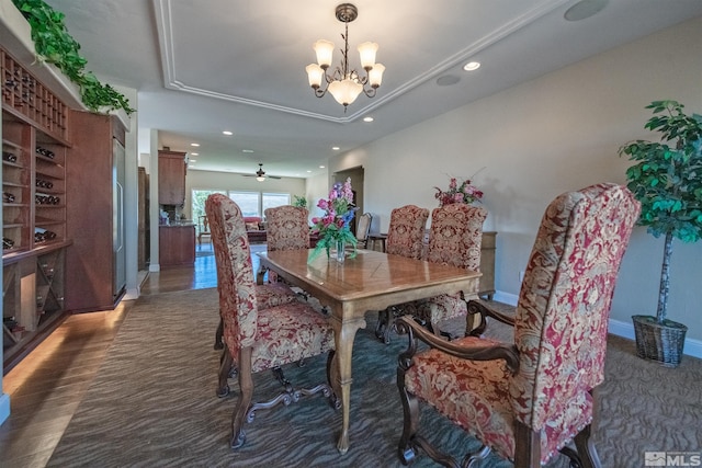 dining room with ceiling fan with notable chandelier, crown molding, dark hardwood / wood-style flooring, and a tray ceiling