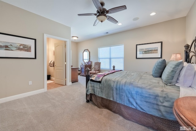 bedroom featuring ensuite bath, ceiling fan, and light colored carpet