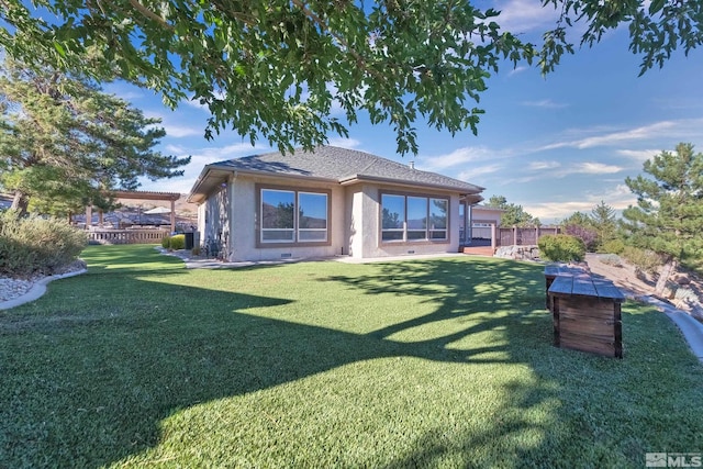 rear view of property with a lawn