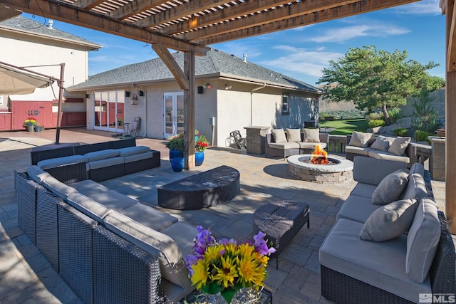 view of patio featuring an outdoor living space with a fire pit