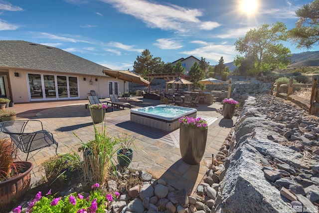 view of swimming pool featuring an outdoor hot tub and a patio