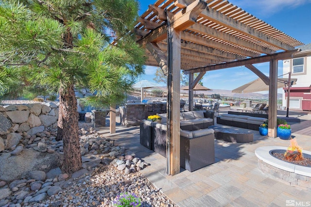 view of patio with a pergola and an outdoor living space with a fire pit