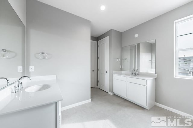 bathroom featuring vanity, tile patterned floors, and a wealth of natural light