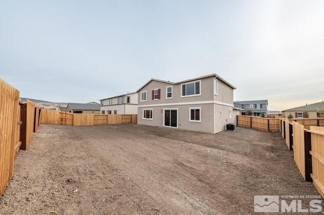 rear view of property featuring central AC unit