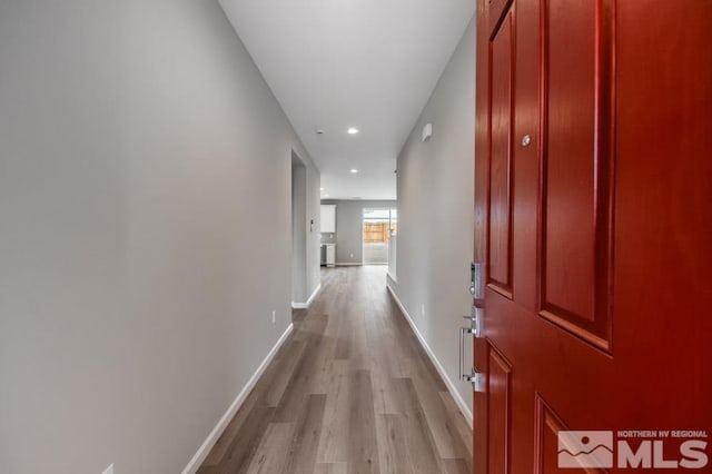 corridor with light hardwood / wood-style floors