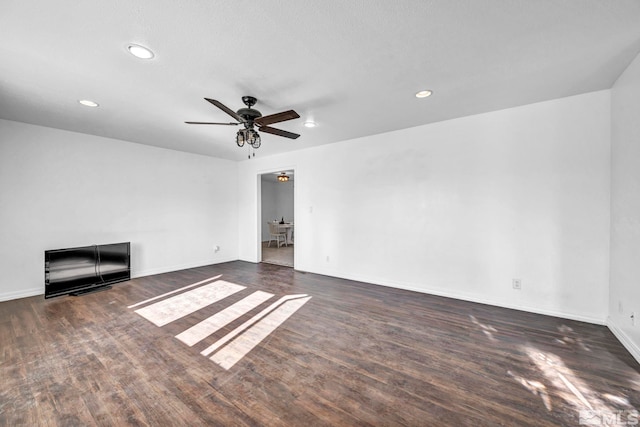 unfurnished room with dark hardwood / wood-style flooring, ceiling fan, and a textured ceiling