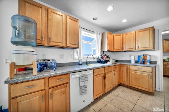 kitchen with white dishwasher, a textured ceiling, light tile patterned flooring, and sink