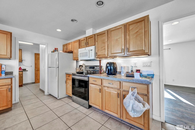 kitchen featuring light wood-type flooring and white appliances