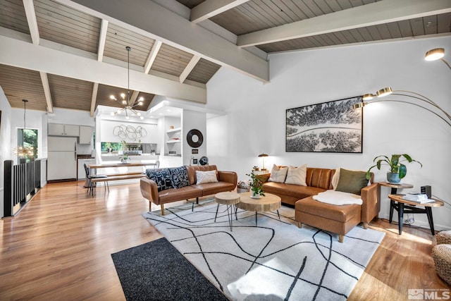 living room featuring a chandelier, wooden ceiling, vaulted ceiling with beams, and light hardwood / wood-style floors