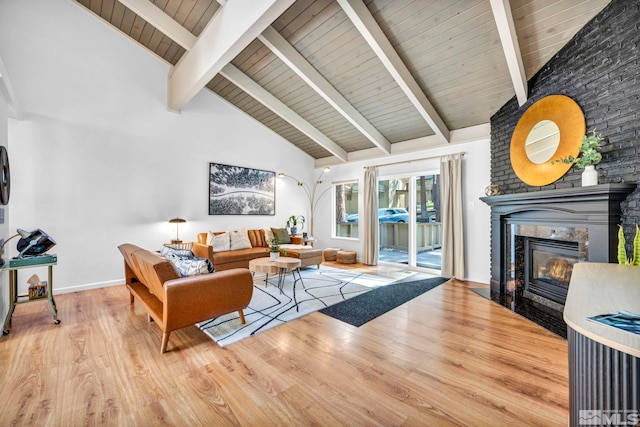 living room featuring beamed ceiling, high vaulted ceiling, hardwood / wood-style flooring, and a fireplace