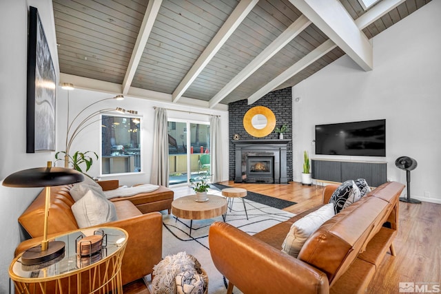 living room with hardwood / wood-style floors, wood ceiling, a fireplace, and vaulted ceiling with beams