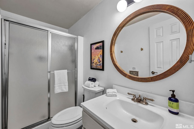 bathroom featuring vanity, toilet, and an enclosed shower