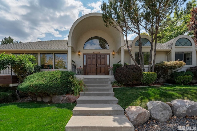 doorway to property with a yard