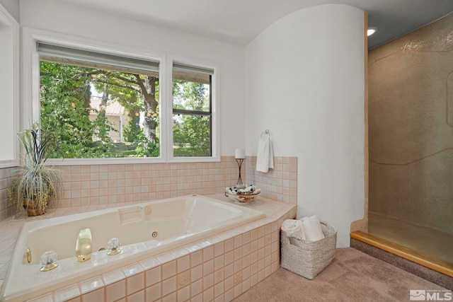 bathroom featuring tiled tub