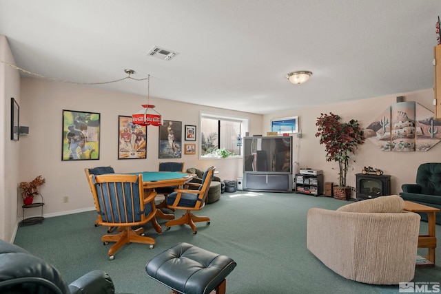 carpeted dining room with a wood stove