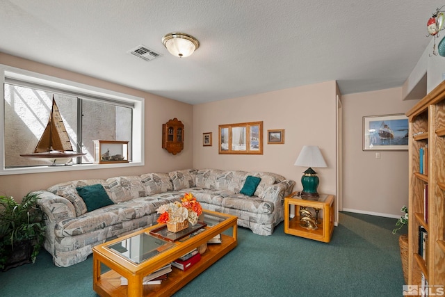 living room featuring carpet and a textured ceiling