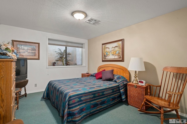 carpeted bedroom featuring a textured ceiling