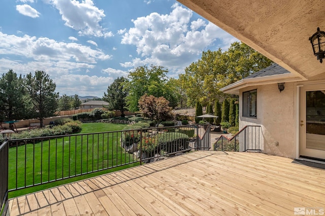 wooden terrace featuring a lawn