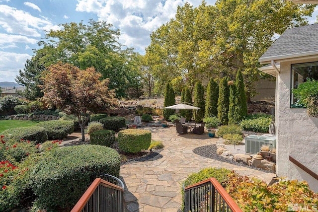 view of yard featuring central AC unit and a patio area