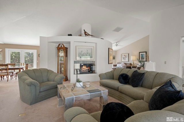 carpeted living room featuring lofted ceiling, ceiling fan, and a fireplace