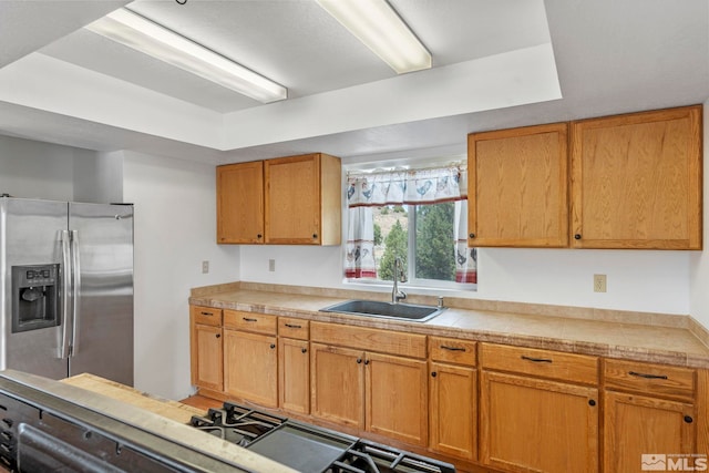 kitchen featuring sink and stainless steel refrigerator with ice dispenser