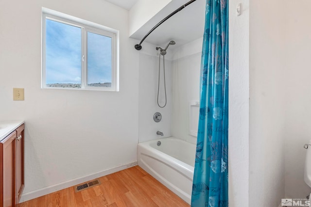 bathroom featuring vanity, hardwood / wood-style flooring, and shower / bath combo