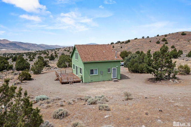 rear view of property with a deck with mountain view